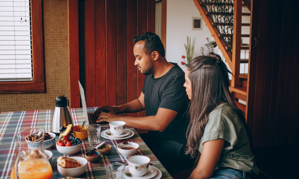 Woman and Man Sitting at Breakfast and Working .pexels
