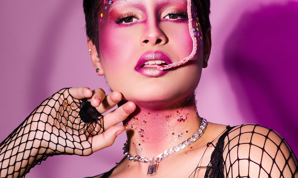 Woman in Creative Makeup Biting a Candy  .pexels