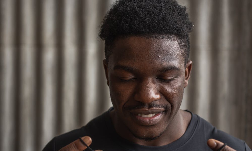 Black man putting on protective mask .pexels