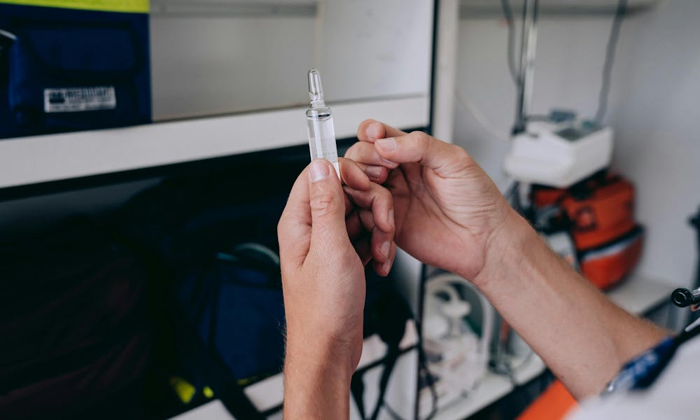 Man Hands Holding Vial of Medicine .pexels