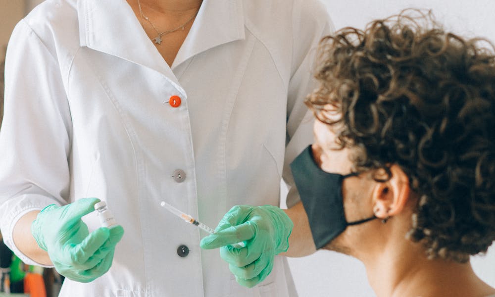 Woman in White Medical Scrub Suit .pexels