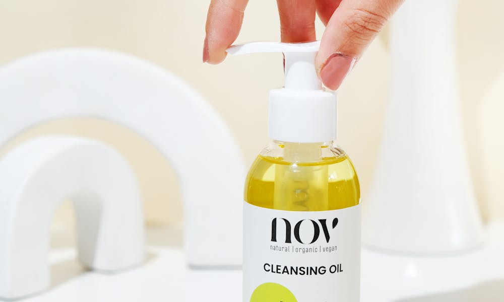 Hand Holding Cleansing Oil Dispenser in Minimalist Setting .pexels