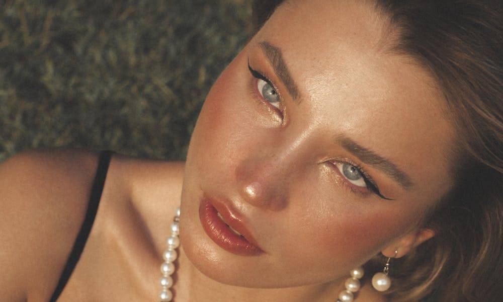Elegant Young Woman with Pearl Necklace Outdoors .pexels