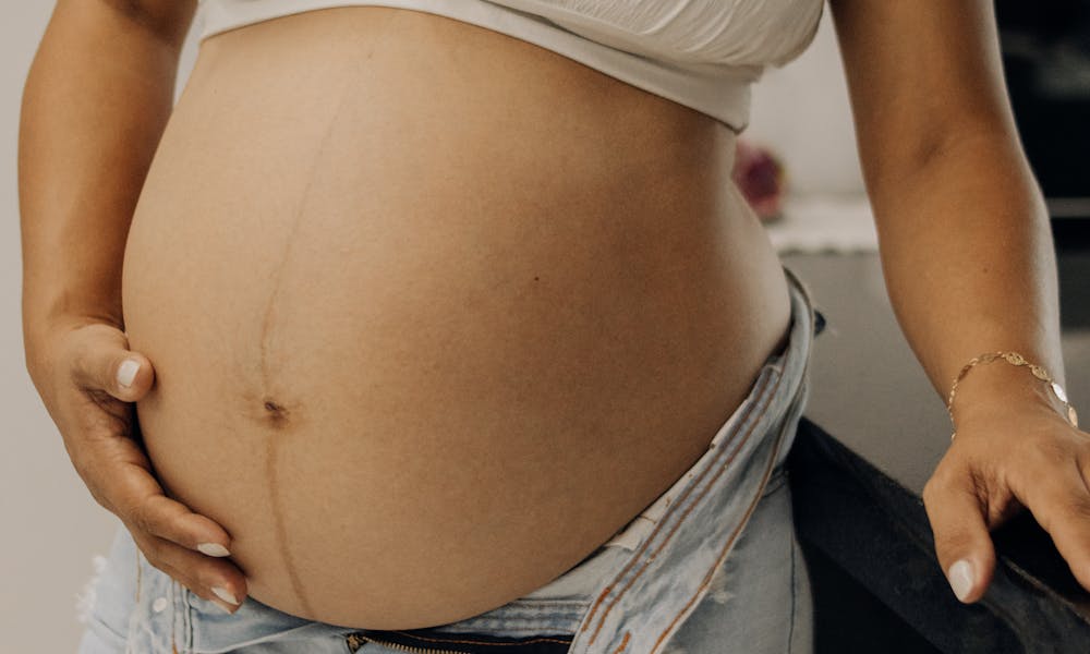 Pregnant Woman in Casual Maternity Outfit Indoors .pexels
