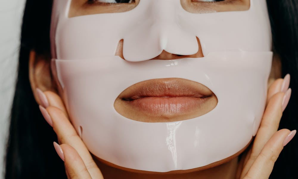 A Woman Wearing a Facial Mask with Her Hands on Her Face .pexels