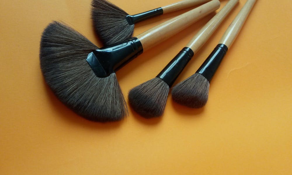Set of Makeup Brushes on Orange Background .pexels