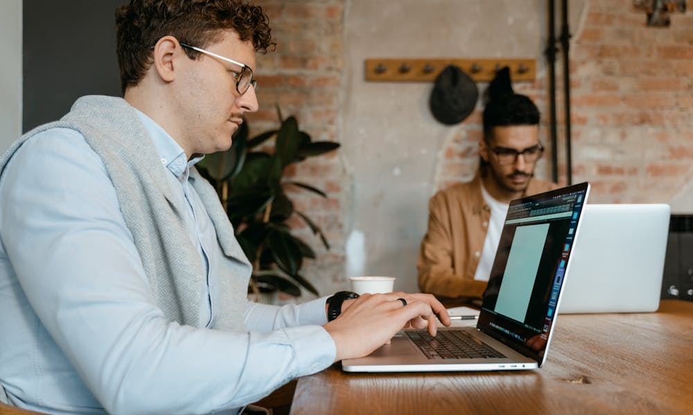 Man in White Dress Shirt Using Macbook Pro .pexels