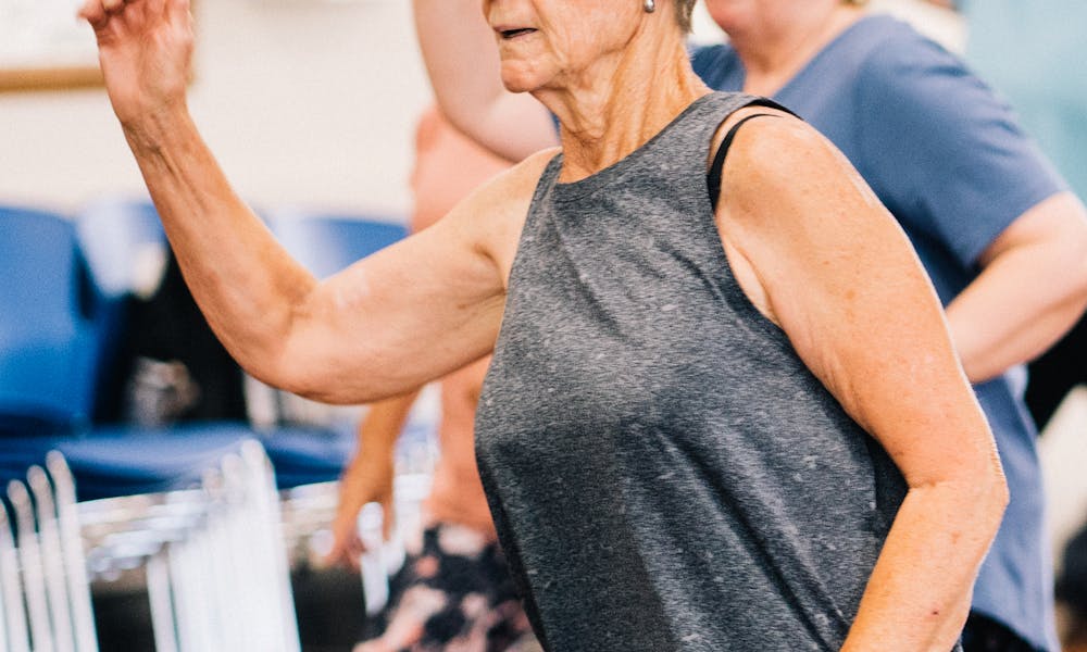 Elderly Woman in Gray Tank Top and Leggings Exercising .pexels