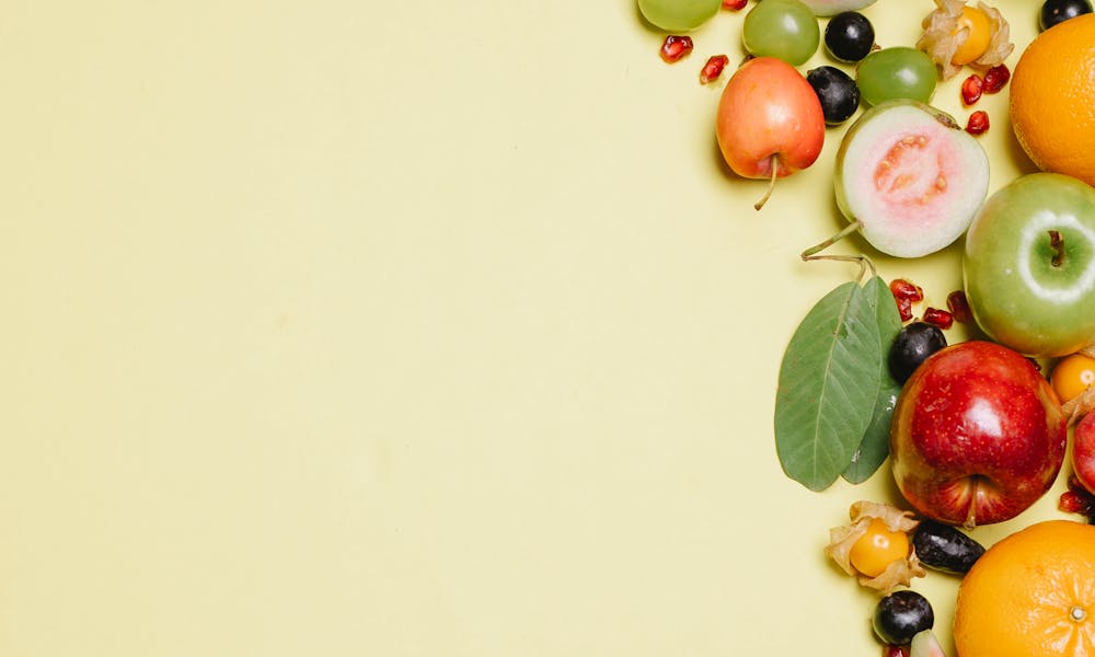 Ripe fresh fruits on beige surface .pexels