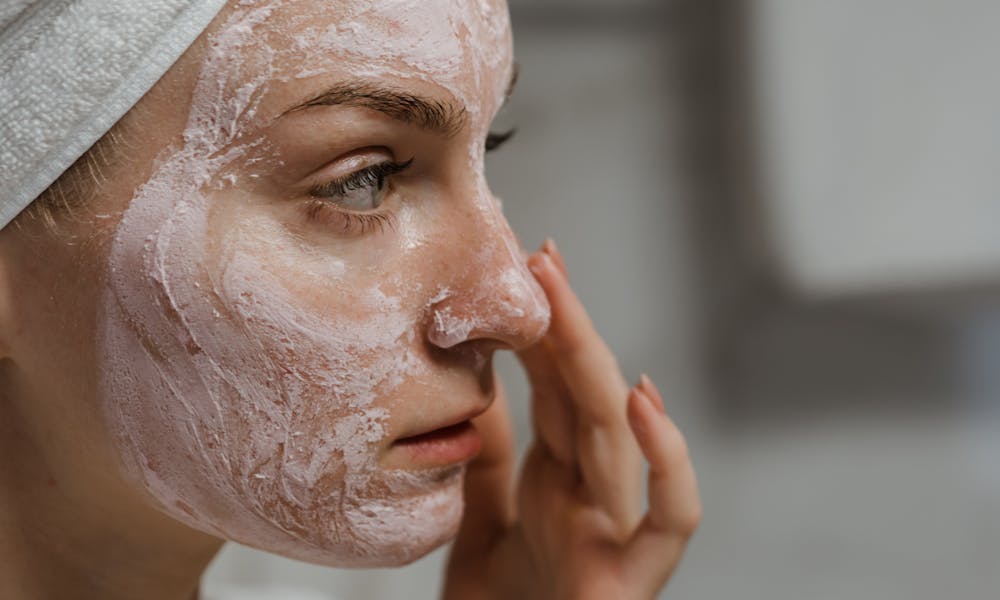 Close-up Photo of a Woman Applying Facial Cream  .pexels