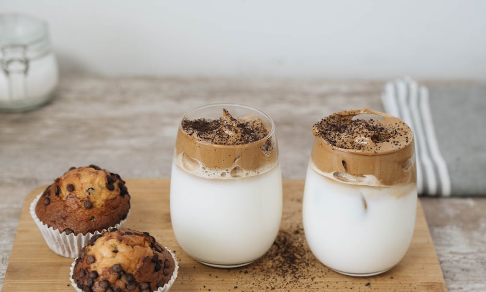 A High Angle Shot of a Dessert in Glasses and Cupcakes on Cutting Board .pexels