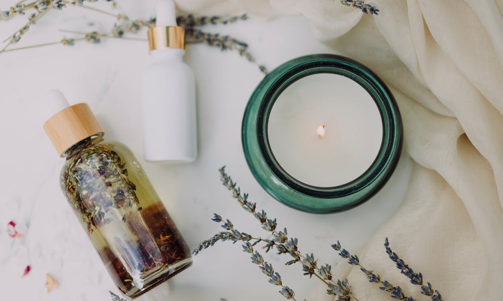 A calming flat lay of spa essentials featuring lavender and candles for relaxation. .pexels