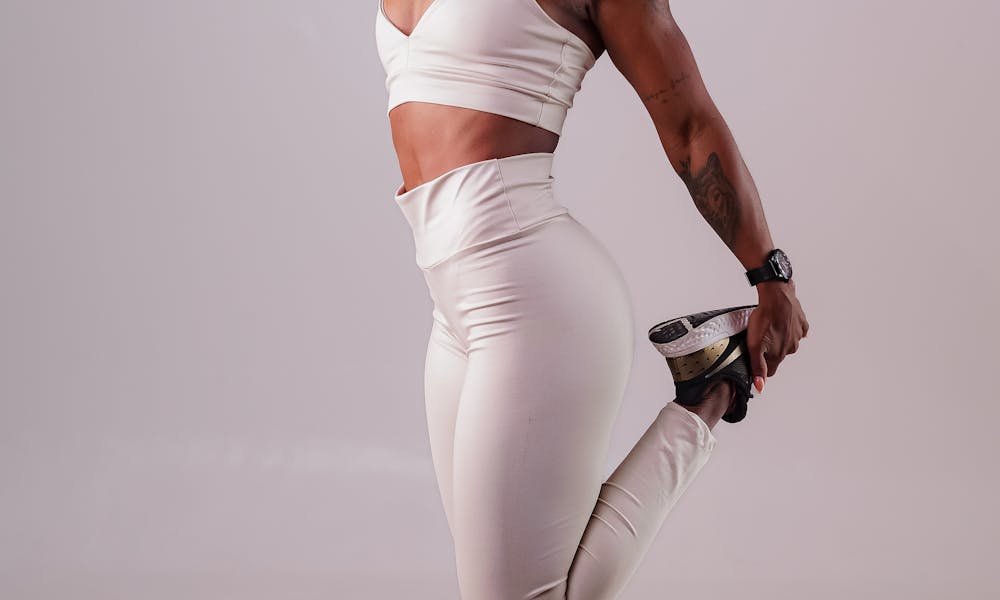 Flexible woman exercising in modern activewear, emphasizing fitness and style. .pexels