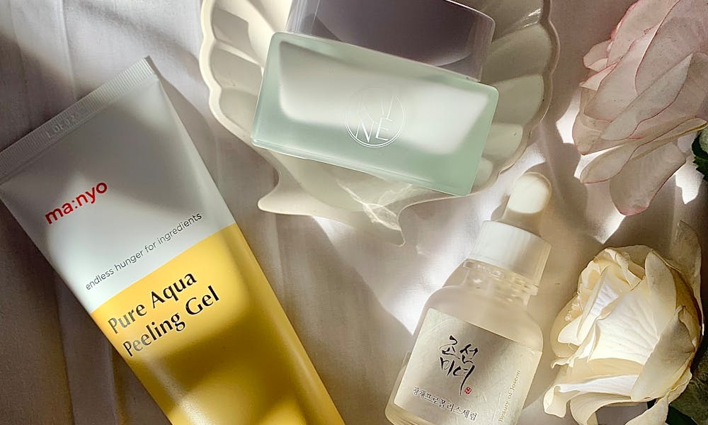 Stylized skincare products arrangement with soft lighting and flowers. .pexels